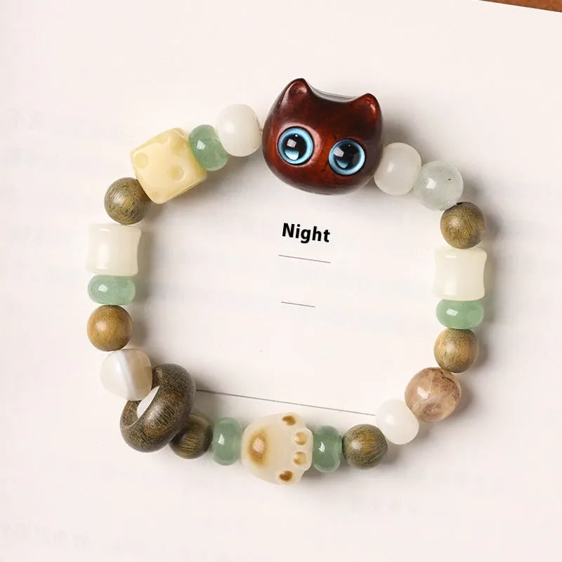 Hand-woven beaded bracelet with jade, bodhi and wood cubes and a wooden Sugar Cat's Paw charm.