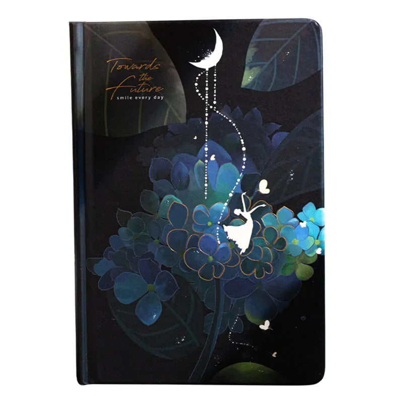 A5 notebook with a luminous cover open to show pages with colour illustrations.