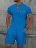 Men's grey waffle weave polo collar short sleeve suit with matching shorts laid flat.