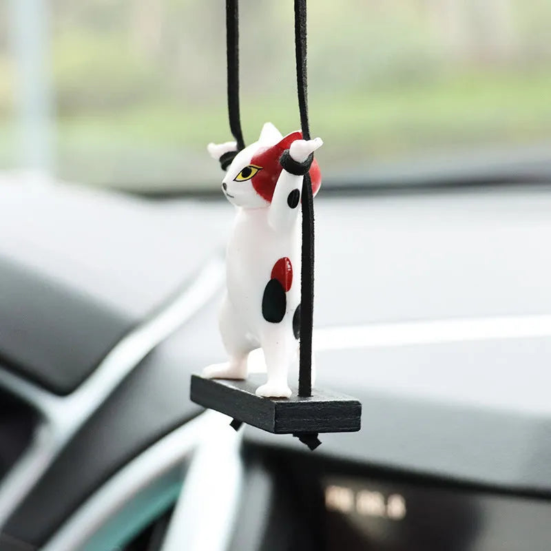 Resin cartoon cat pendant for car interior decoration with adjustable rope, shown in various colours.