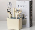Six-piece white stainless steel kitchen gadget set arranged on a neutral background