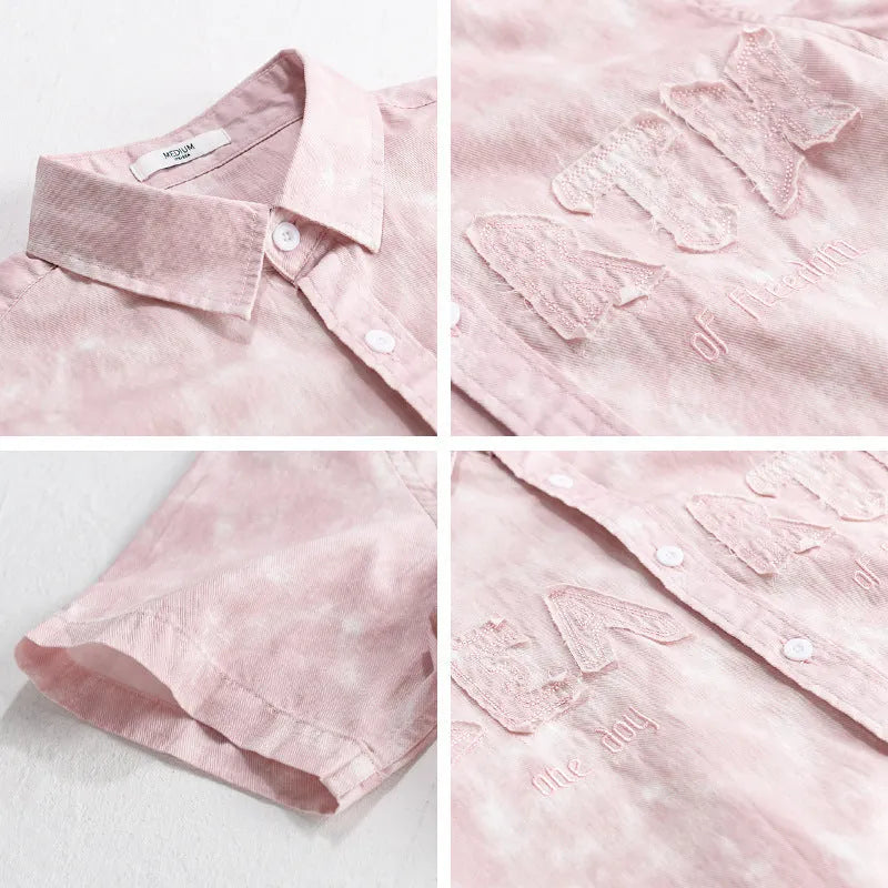 Men's grey white loose fit short sleeve cotton cardigan with a hanging dyed print, shown on a hanger.