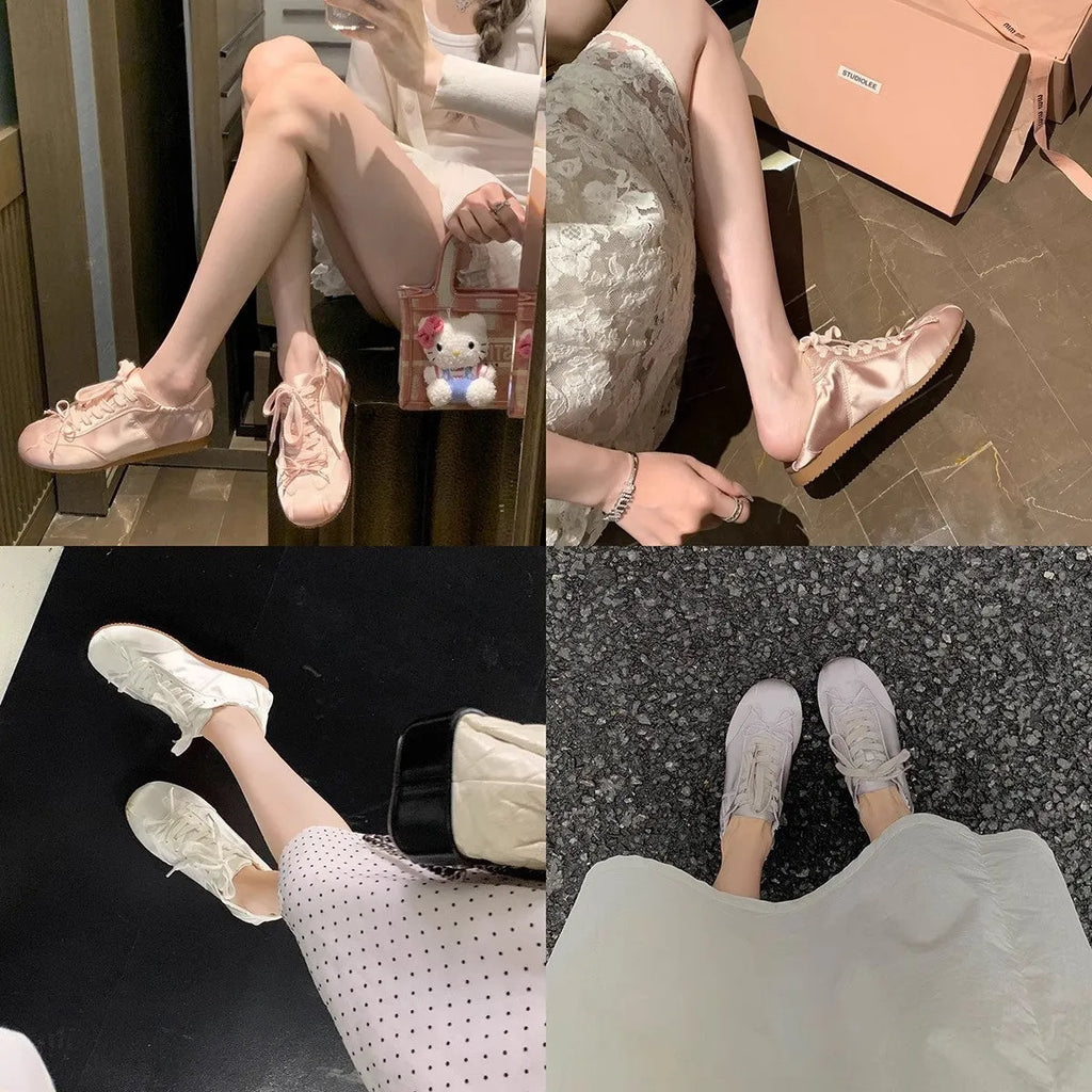 Women's silver satin ballet flats with round toe and white front lace-up on a rubber sole.