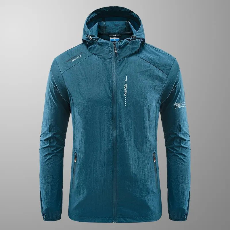 Man wearing a lightweight grey hooded nylon jacket suitable for summer outdoor activities.