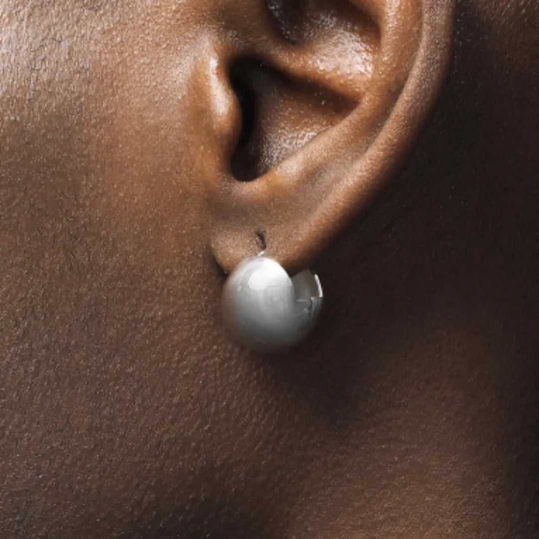 Pair of 925 sterling silver hip-hop style stud earrings for men and women on white background