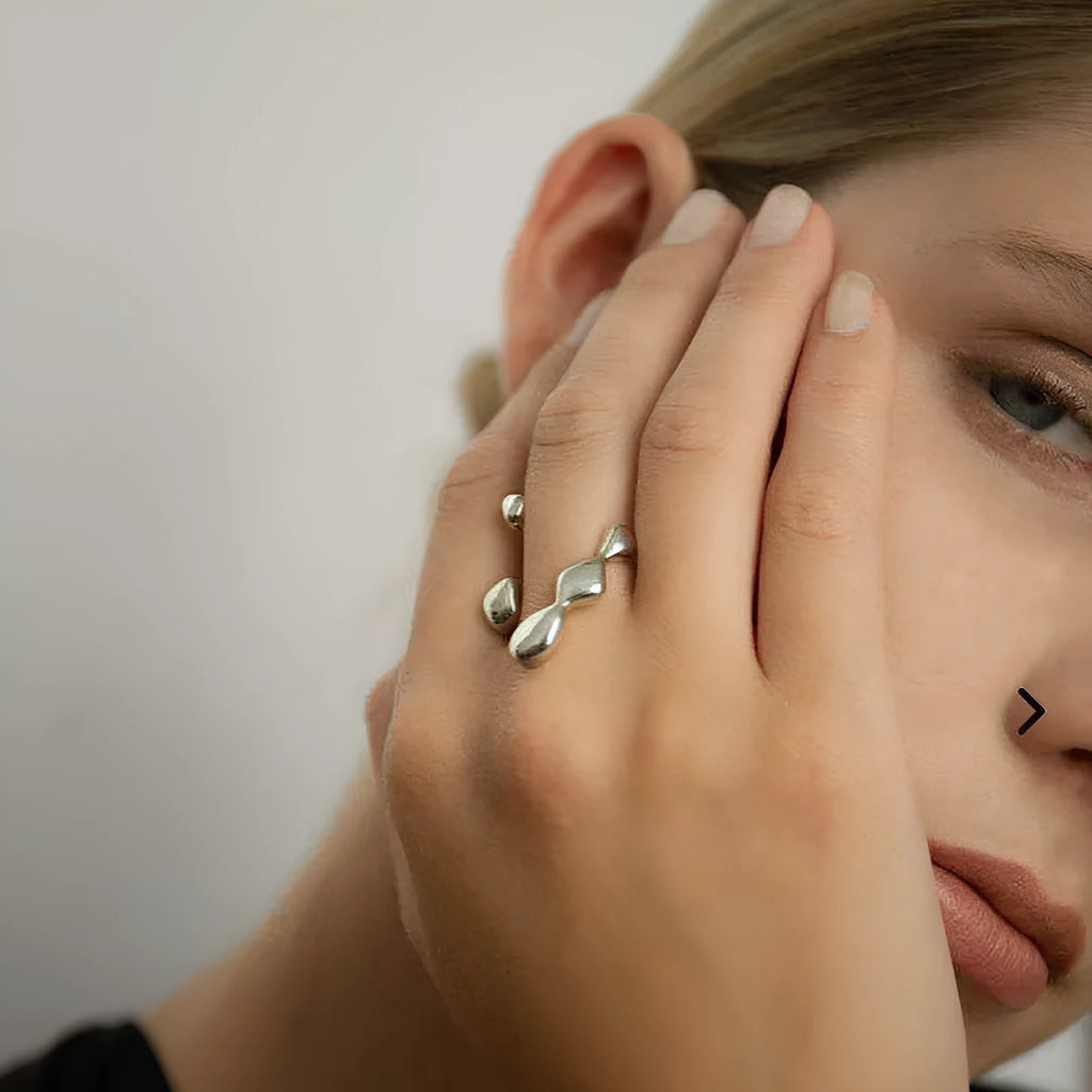 Brass opening ring for women with spherical design in gold or silver finish.