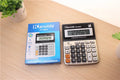Silver aluminium desktop calculator with compact dimensions approximately 14.5 x 11 x 2.5 cm on a desk