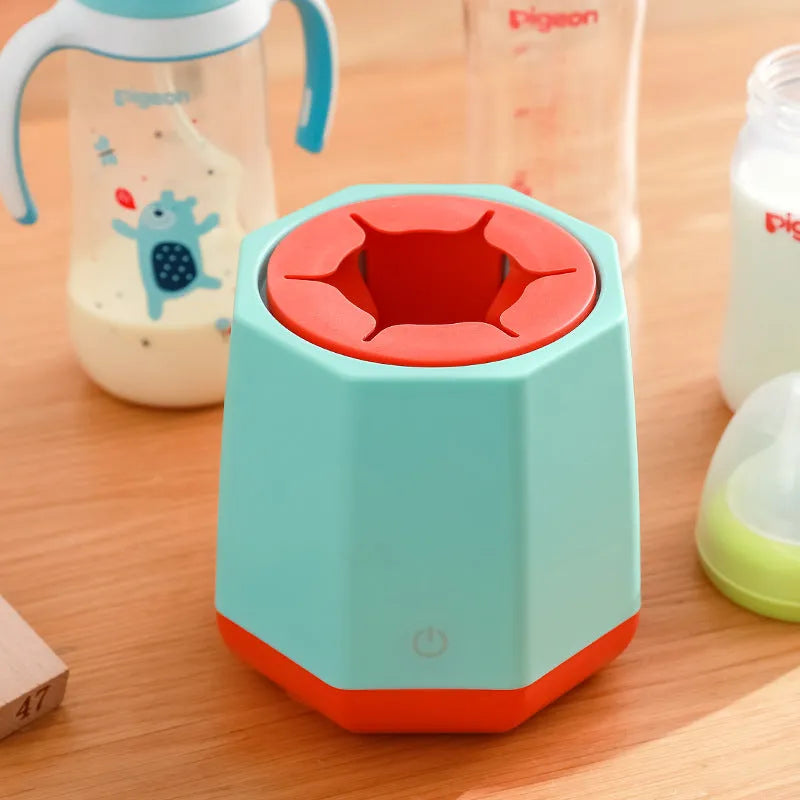 White baby electric milk shaker with green silicone slot holding a round baby bottle, 110x110x110mm