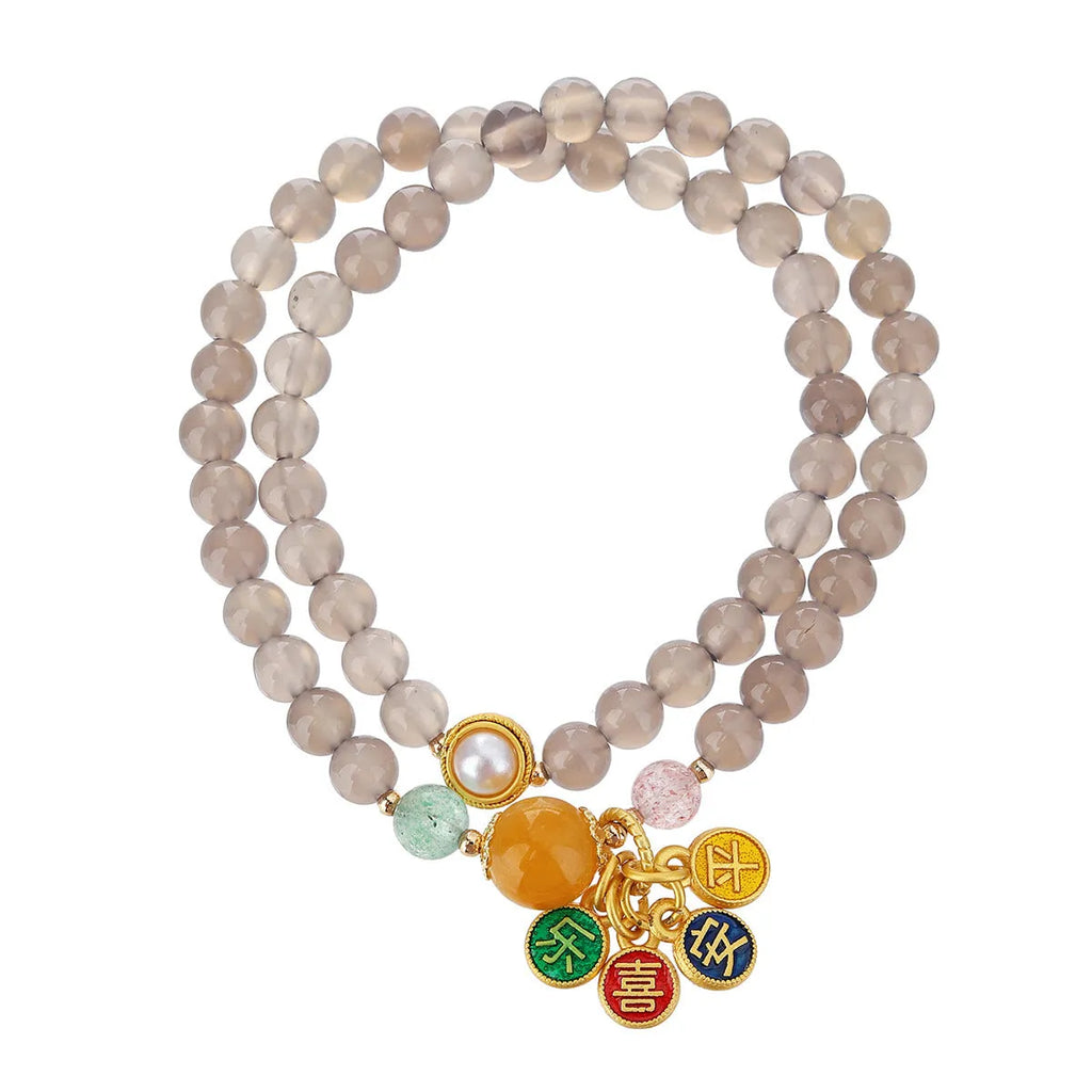 Close-up of a natural grey agate two-circle bracelet with retro design on a wrist.