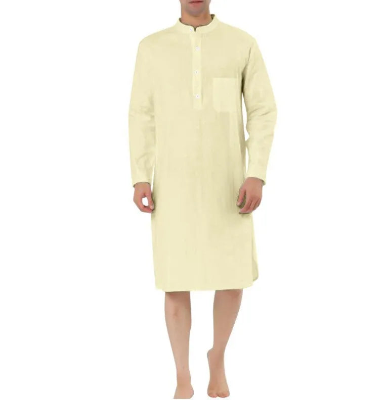 Man wearing a light blue cotton shirt robe with front pockets, showing the full-length opening and relaxed fit.