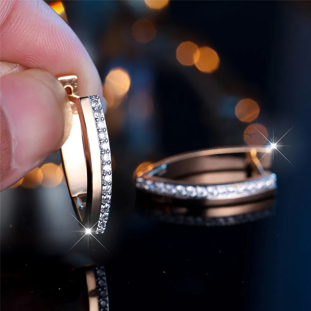 Close-up of women's geometric V-shaped champagne gold ear clips with a clip-on back.