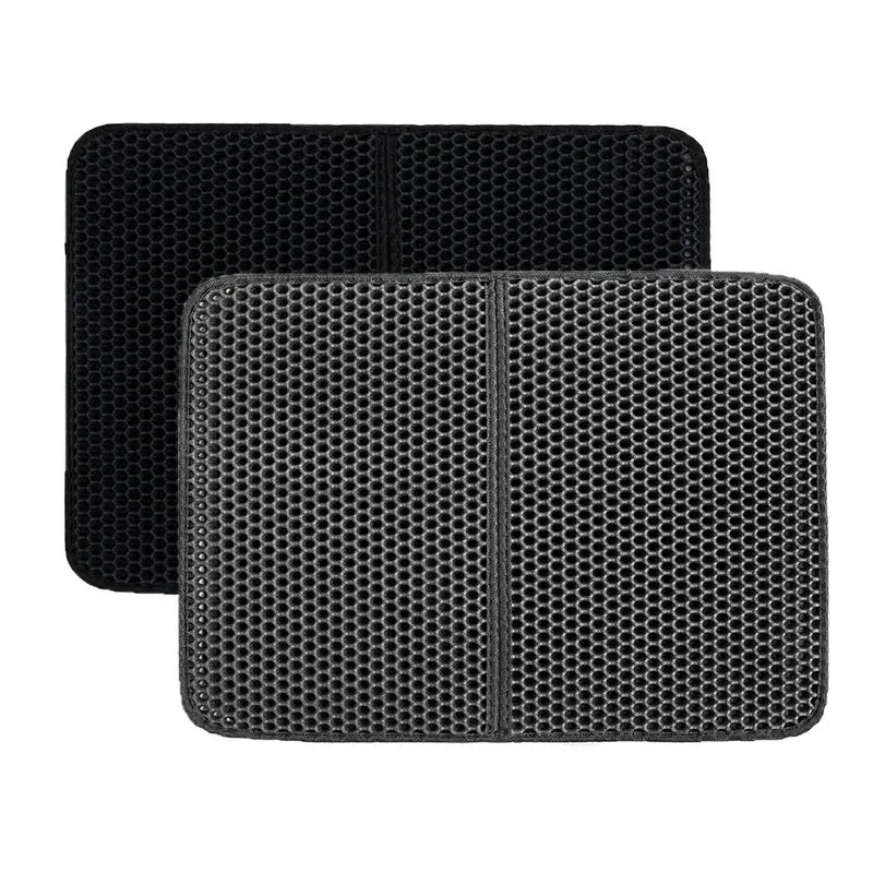 Black waterproof EVA cat litter mat with honeycomb texture and quilted edge on a wooden floor