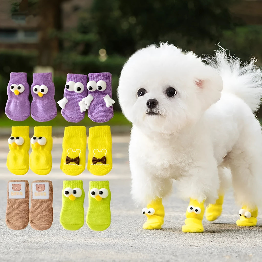 Dog wearing green non-slip socks with cartoon big eyes pattern on wooden floor