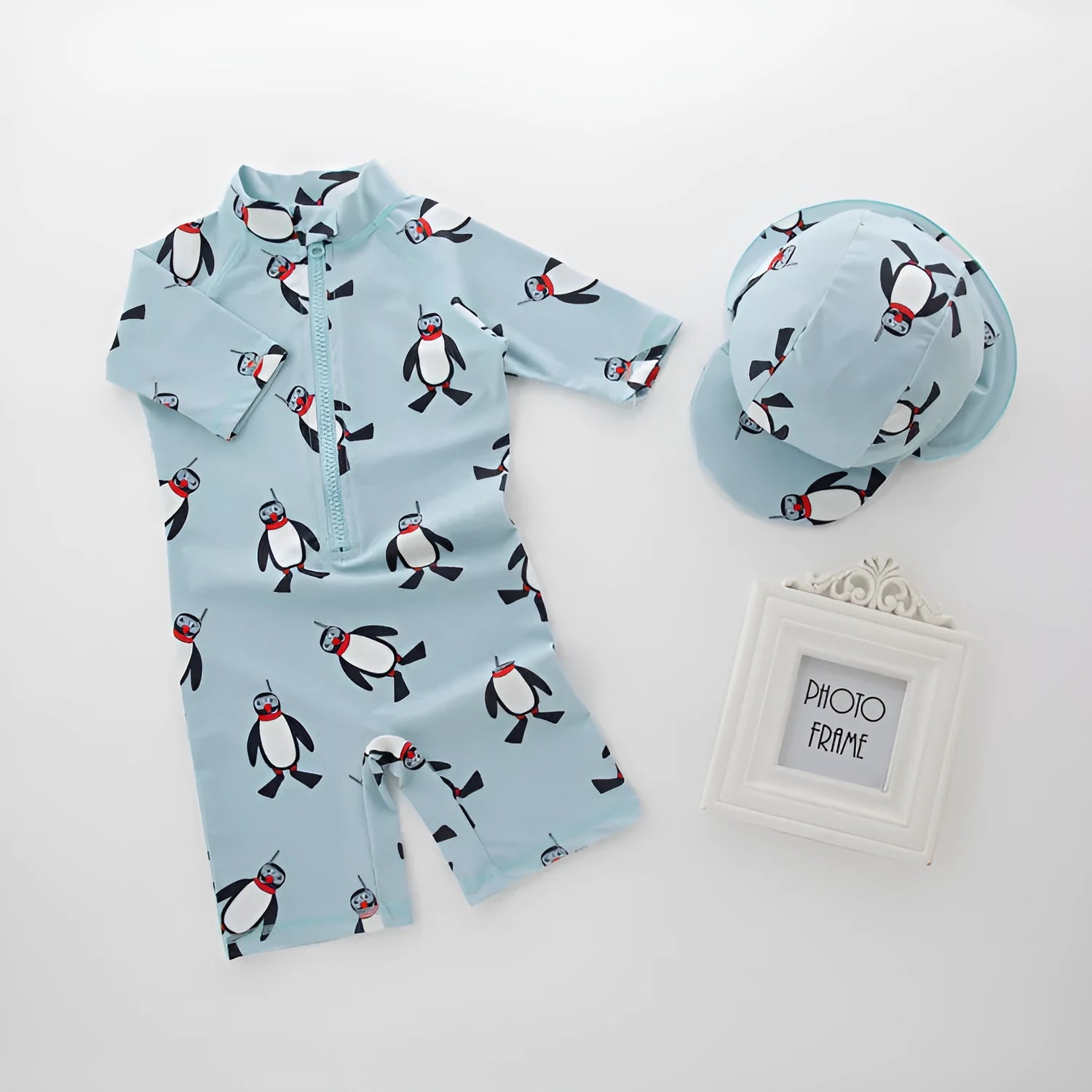 Boy's long sleeve penguin print swimsuit two-piece set with matching swimming cap