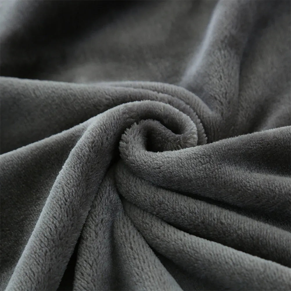 Tweed electric heating blanket in solid grey colour on a bed