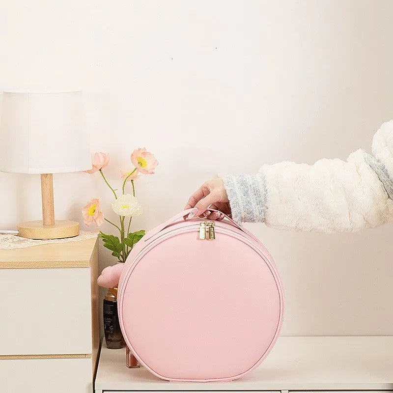 Round pink PU leather LED makeup bag open showing internal mirror, lights, and lattice partitions.