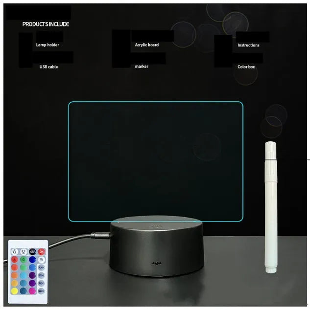 Black 3D acrylic message board lamp with remote control and marker pen on a desk.