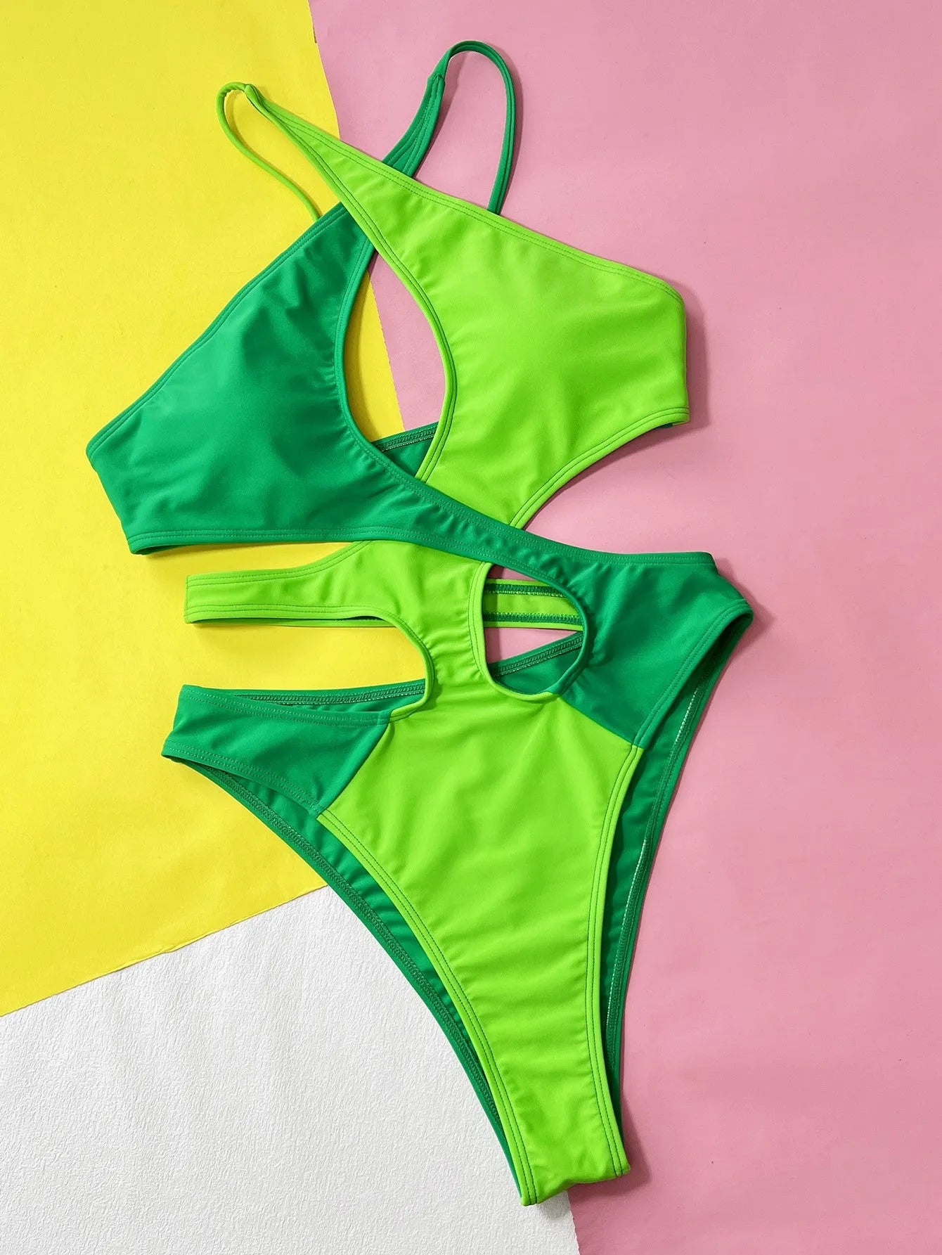 Green women's one-piece swimsuit with hollow contrast colour design