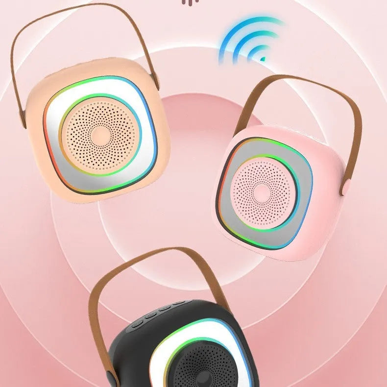 Wireless karaoke microphone with LED lights held next to its separate Bluetooth audio unit
