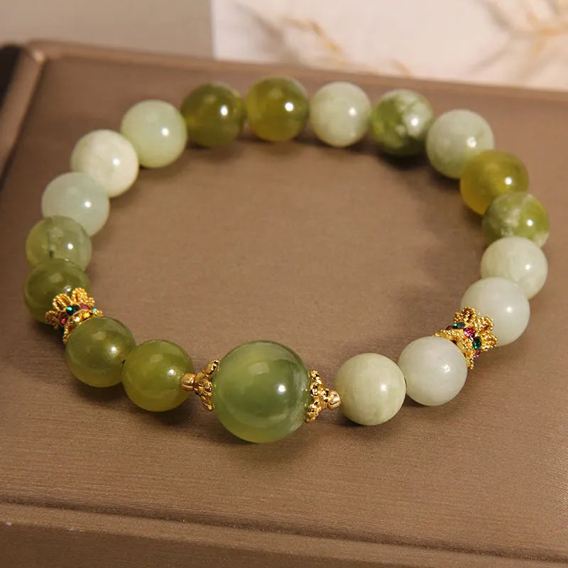Women's bracelet made of green Xiuyan jade with an original design on a wrist.