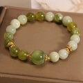 Women's bracelet made of green Xiuyan jade with an original design on a wrist.
