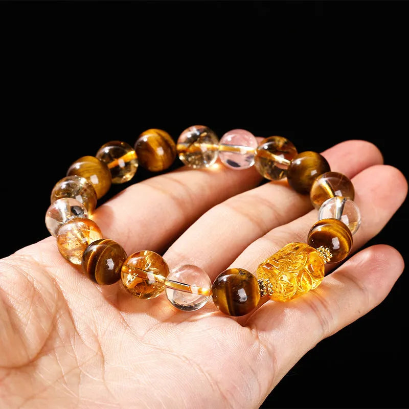 Close-up of a yellow tiger's eye and citrine gemstone bracelet with 10mm round beads and a steel clasp.