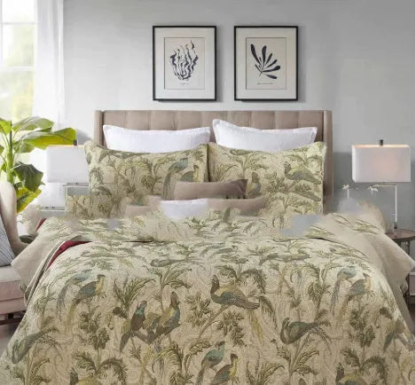 Blue American floral and bird patterned cotton quilted bedspread set on a bed, showing the 230x250 cm size