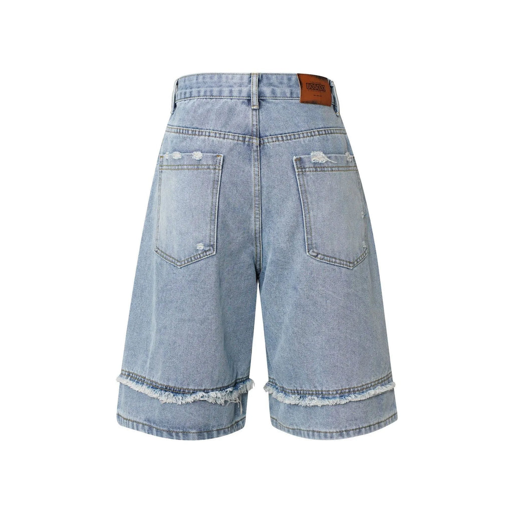 Distressed raw edge denim shorts in straight leg cut, shown in light blue.