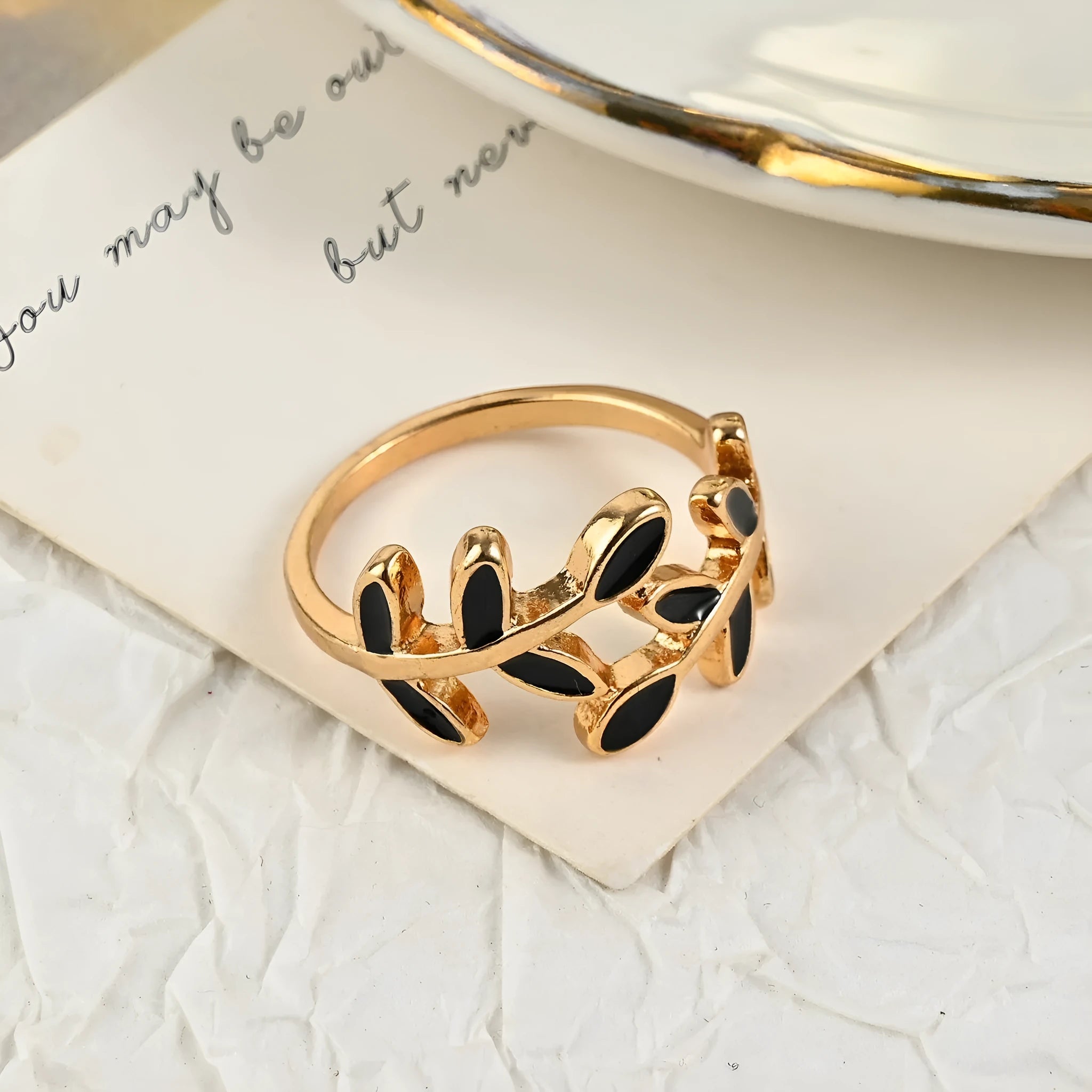 Gold geometric leaf and floral acrylic ring for women on a white background.
