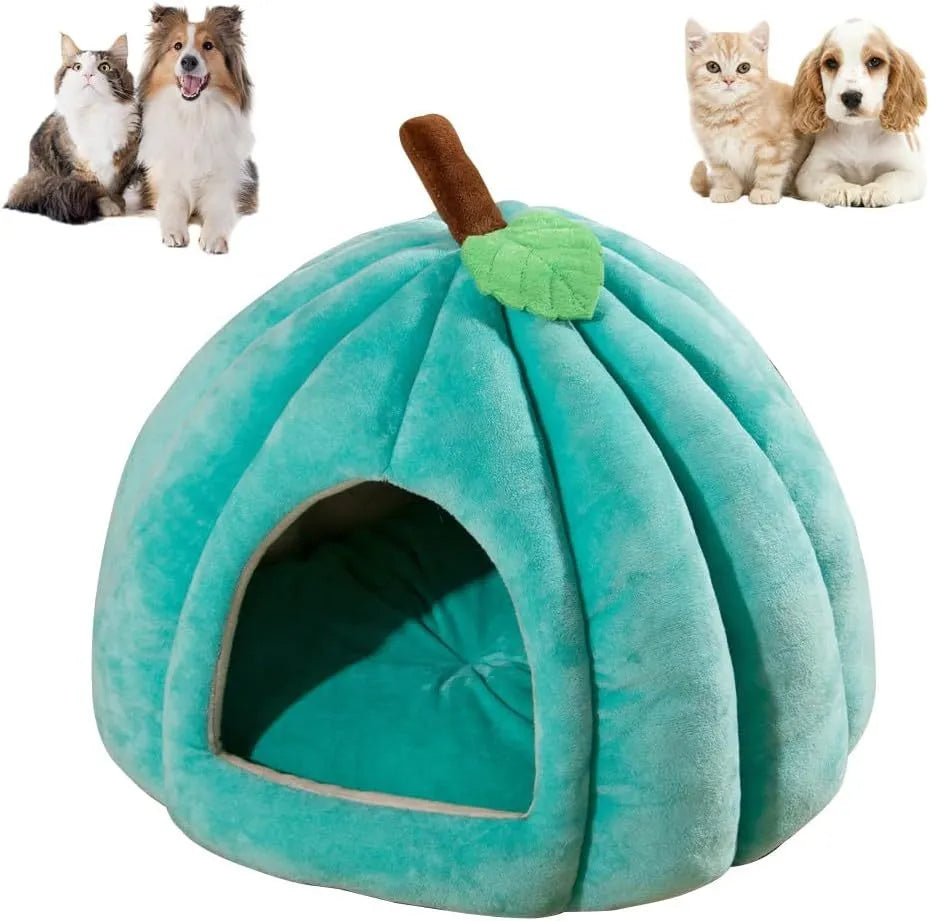 Pumpkin-shaped plush cat cave bed with a round entry hole on a wooden floor.