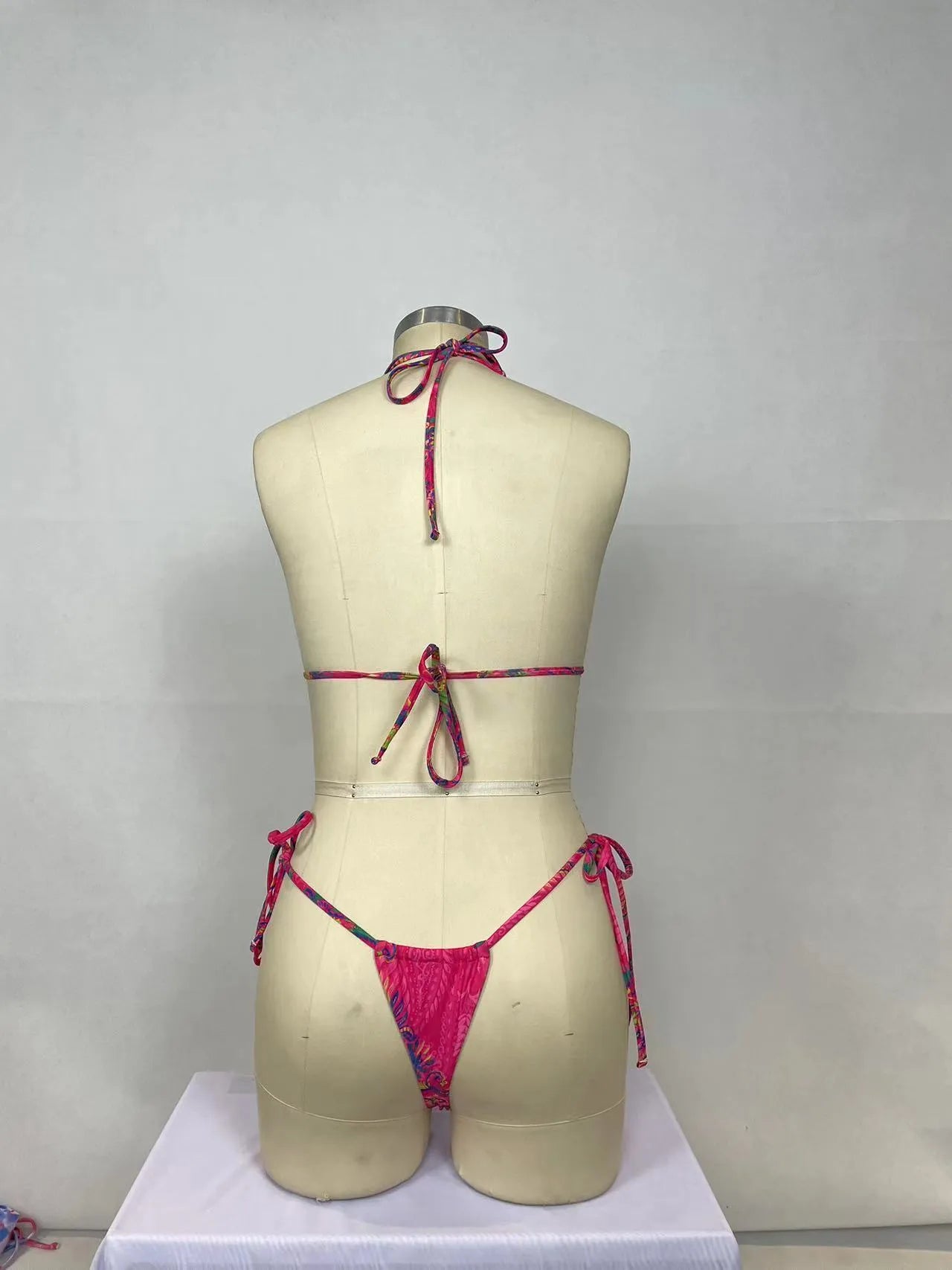 Pink women's nylon bikini two-piece set with triangle top and briefs for swimming.
