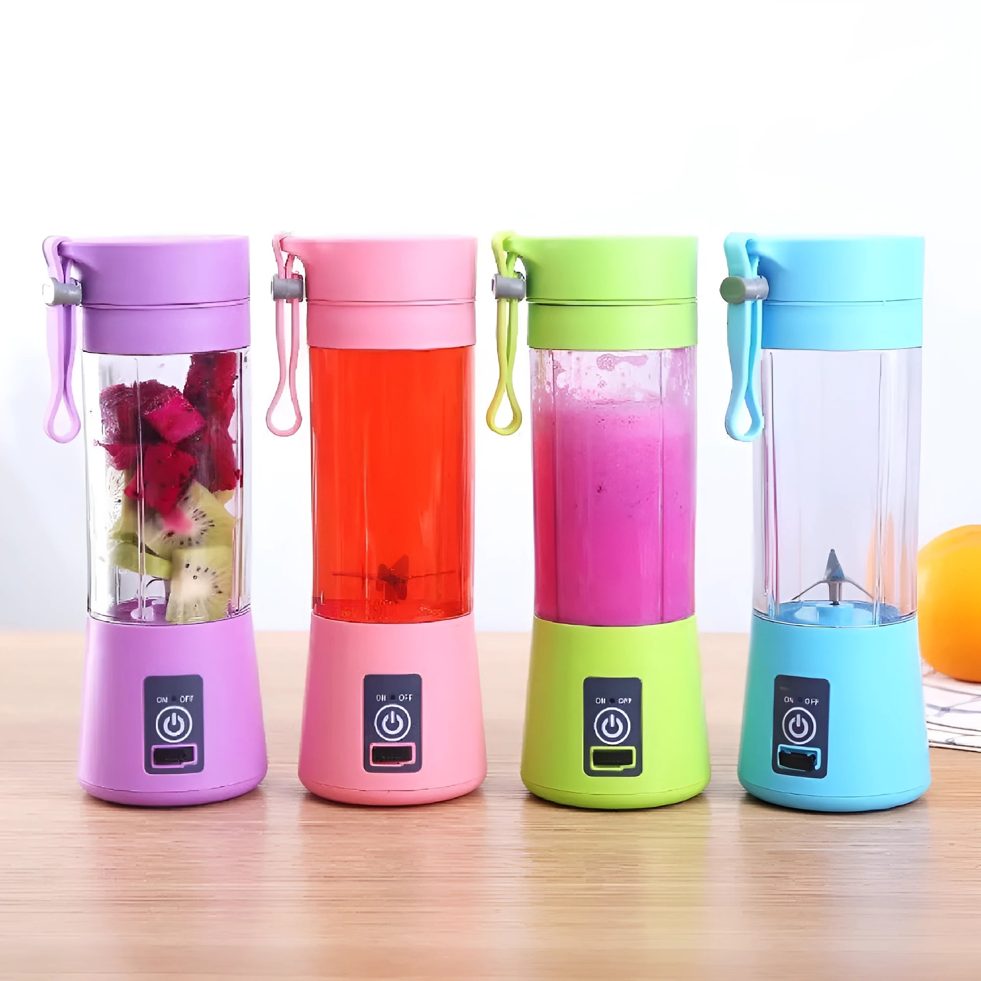 Pink portable USB blender with six blades and a 380ml cup on a kitchen counter.