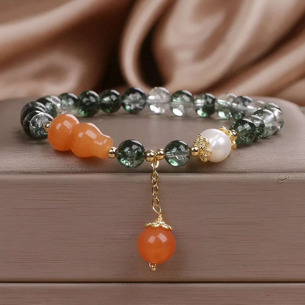 Green phantom quartz crystal bracelet with pearl and rhinestone accents on a white background, 17cm women's size