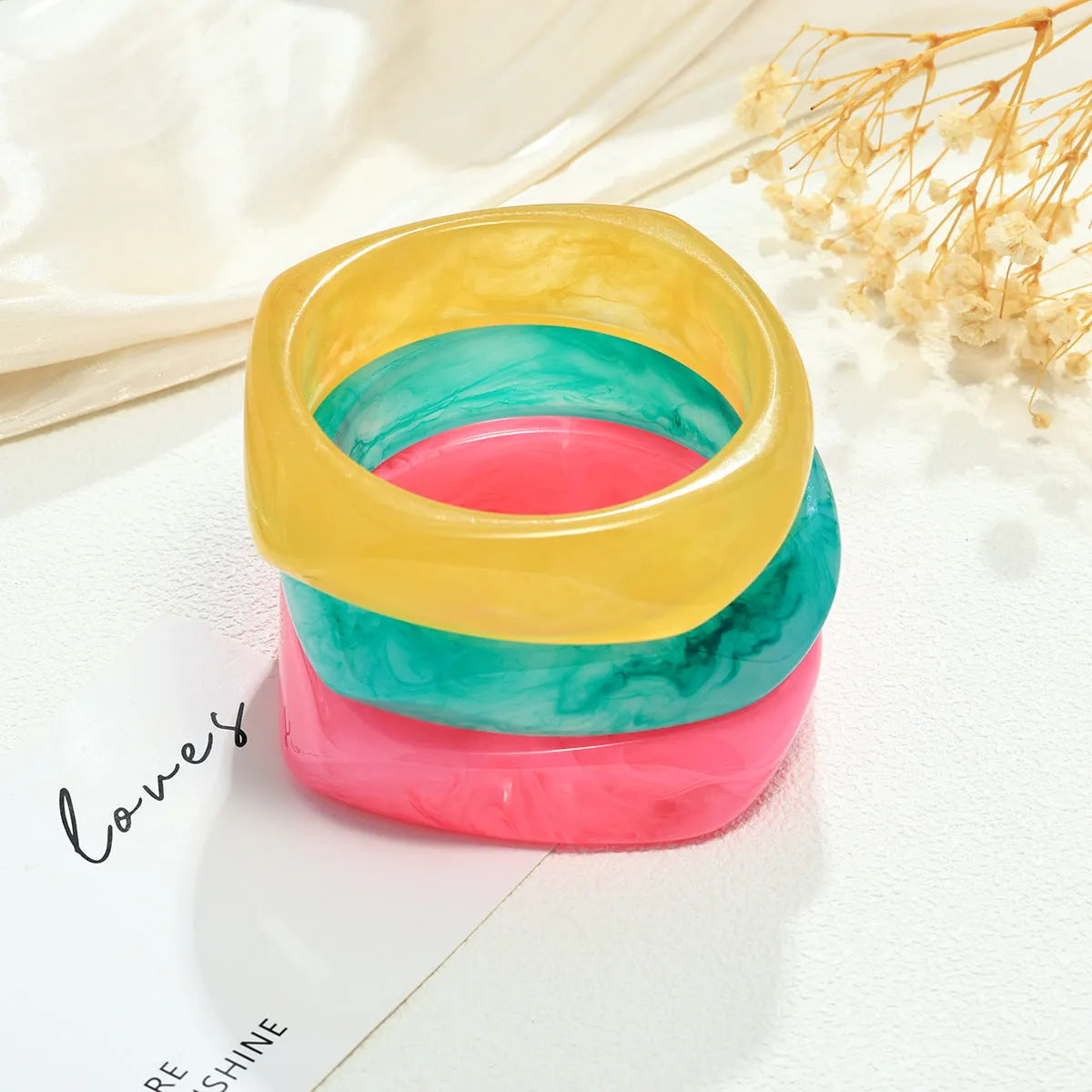 Resin arc bracelet in coffee colour with geometric blooming design and electroplating finish