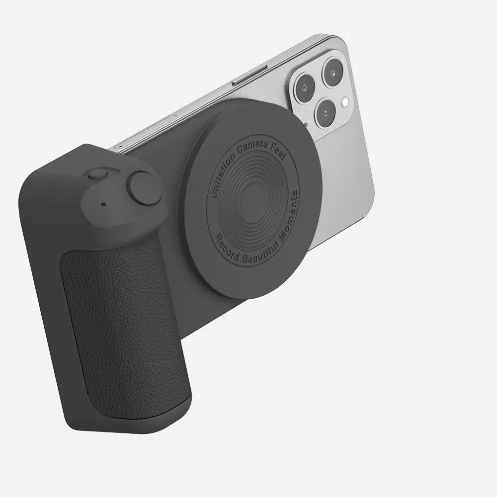 Black magnetic phone camera holder with rotatable grip on wooden table demonstrating phone attachment
