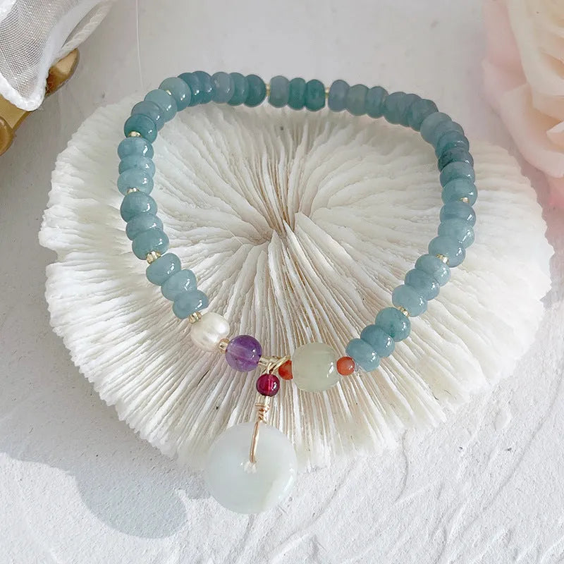 Natural blue water Hetian jade bracelet with carved gourd charm and engraved peace buckle