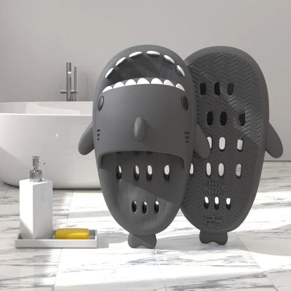 Shark-inspired shower slides with drain holes, featuring authentic shark design details and quick-drying EVA material