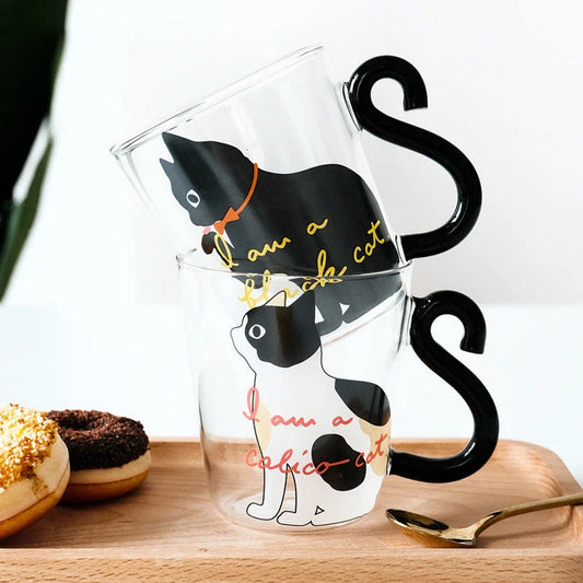 Adorable cat-shaped glass mug with a playful cat tail handle, perfect for coffee, tea, and juice lovers