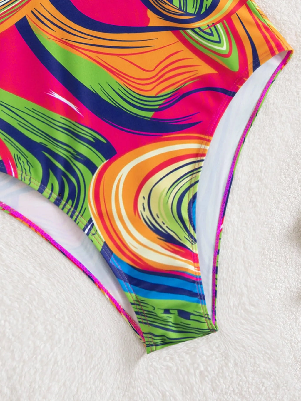Women's deep V-neck one-piece swimsuit with spaghetti straps in a printed pattern