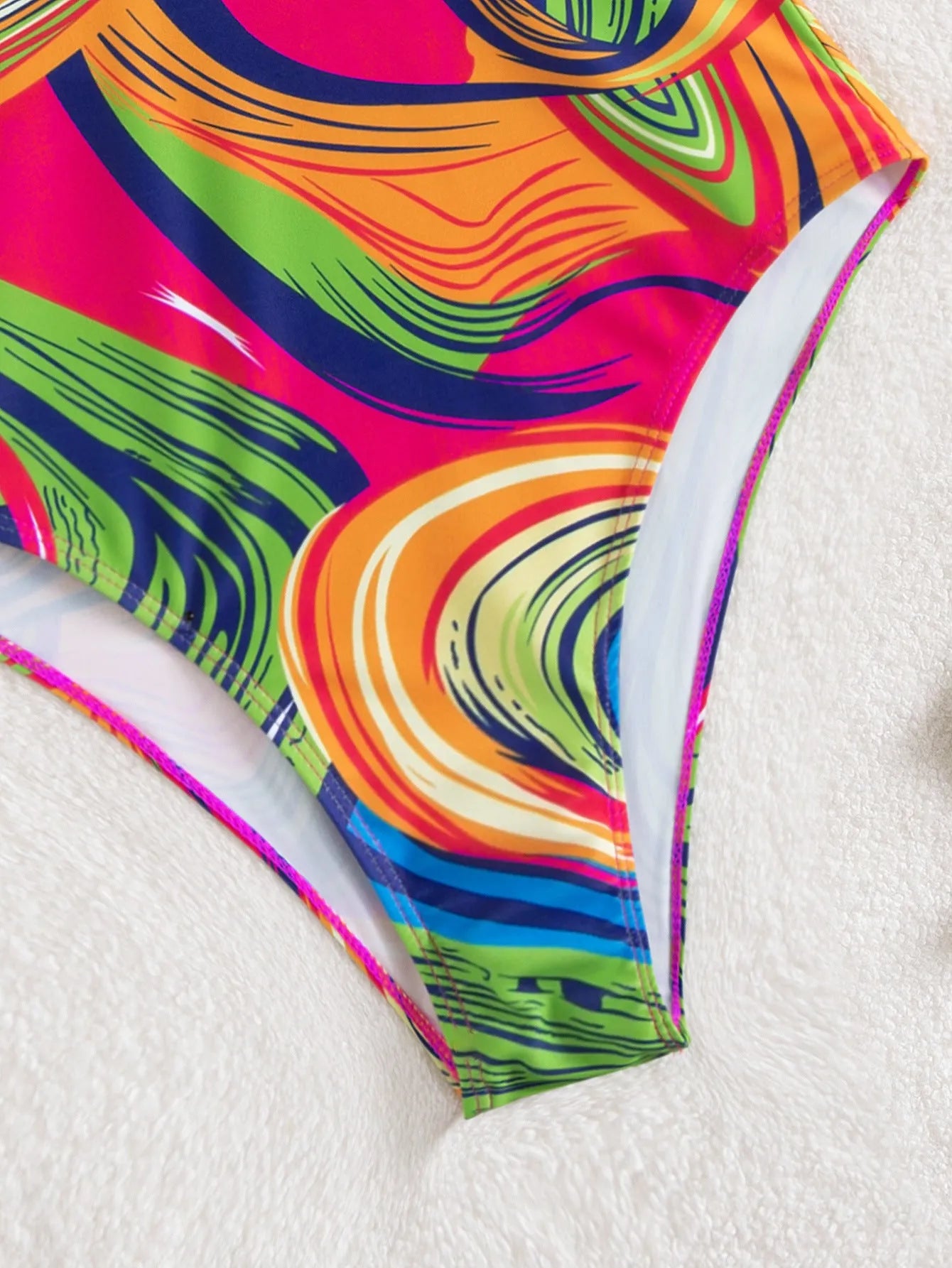 Women's deep V-neck one-piece swimsuit with spaghetti straps in a printed pattern
