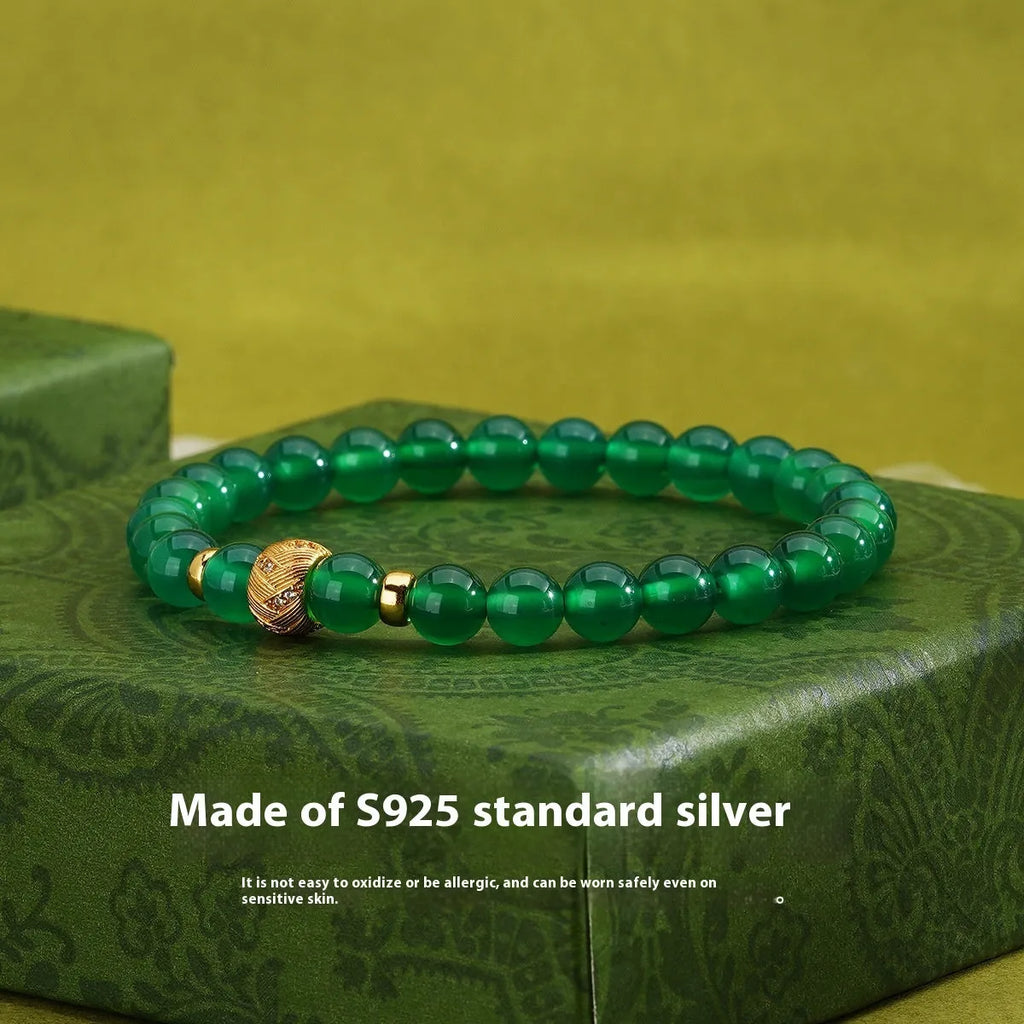 Green agate and sterling silver bracelet with geometric beads and yellow gold plating.