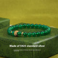 Green agate and sterling silver bracelet with geometric beads and yellow gold plating.