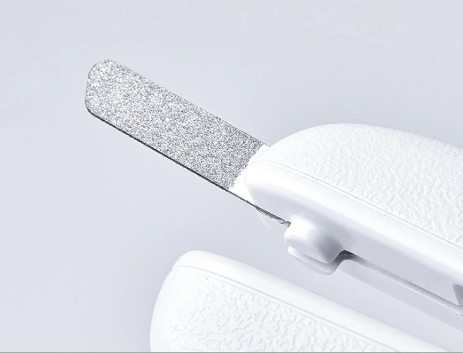 White LED pet nail clippers with a transparent anti-splash guard and an integrated nail file on a grey background.