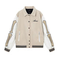 Apricot and brown woolen jacket with embroidered bone pattern detail on front.