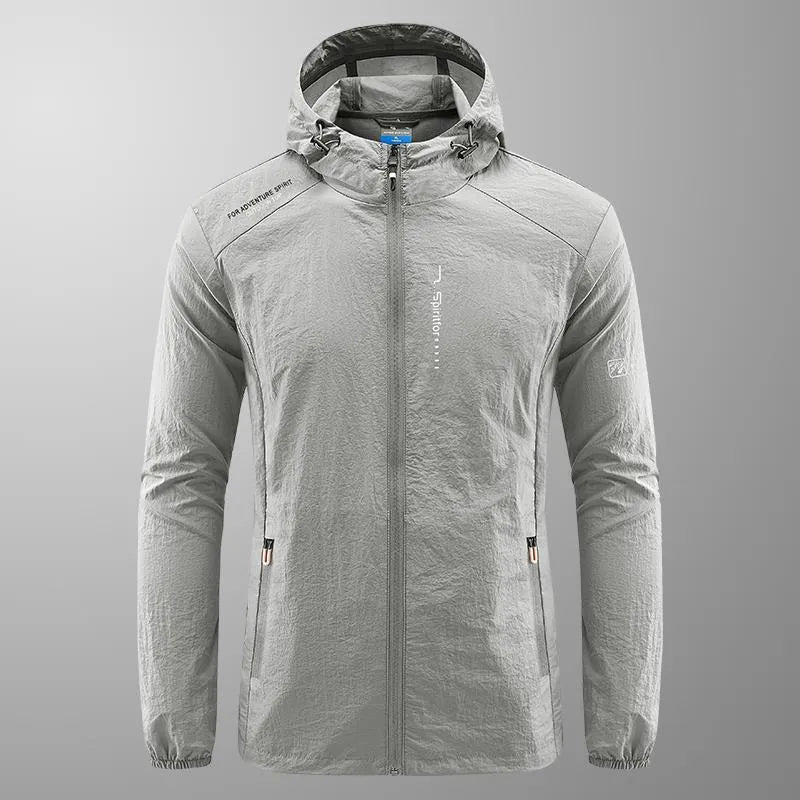 Man wearing a lightweight grey hooded nylon jacket suitable for summer outdoor activities.