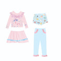 Girl's gilded metallic mermaid swimsuit set with top, skirt, trousers, and shorts laid flat.