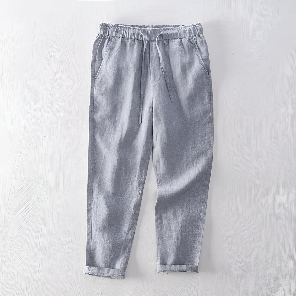Men's straight leg linen trousers in dark grey, shown laid flat.