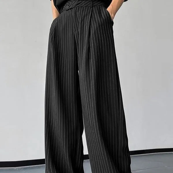 Black men's casual trousers with vertical stripes and front pleats laid flat.