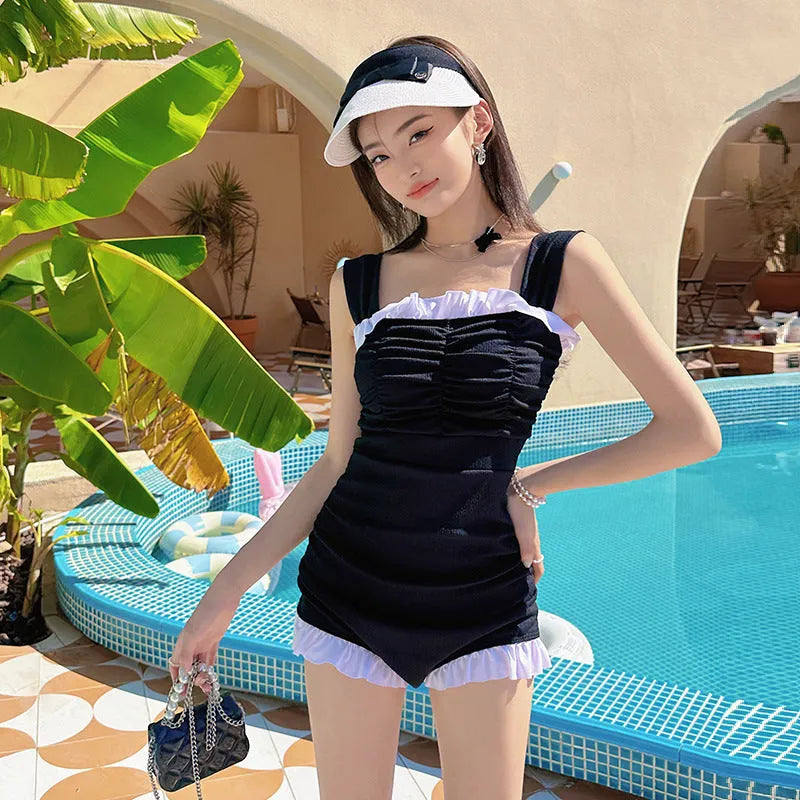 Women's black suspender-style one-piece swimsuit in polyester fabric