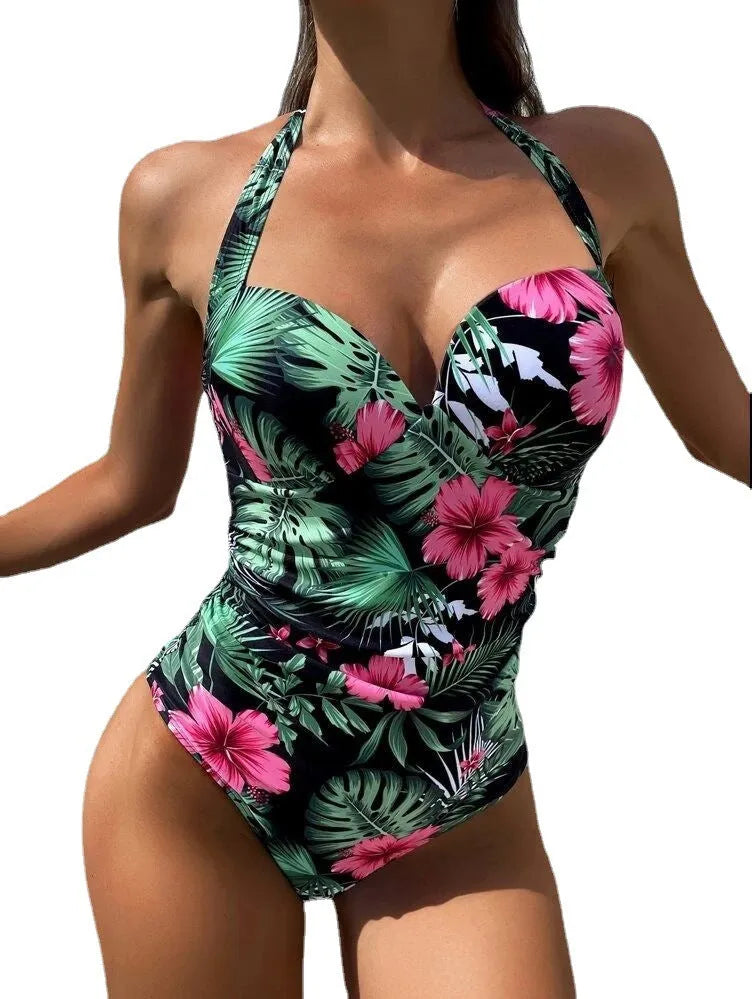 Brown printed halter neck one-piece swimsuit with a backless design on a mannequin.